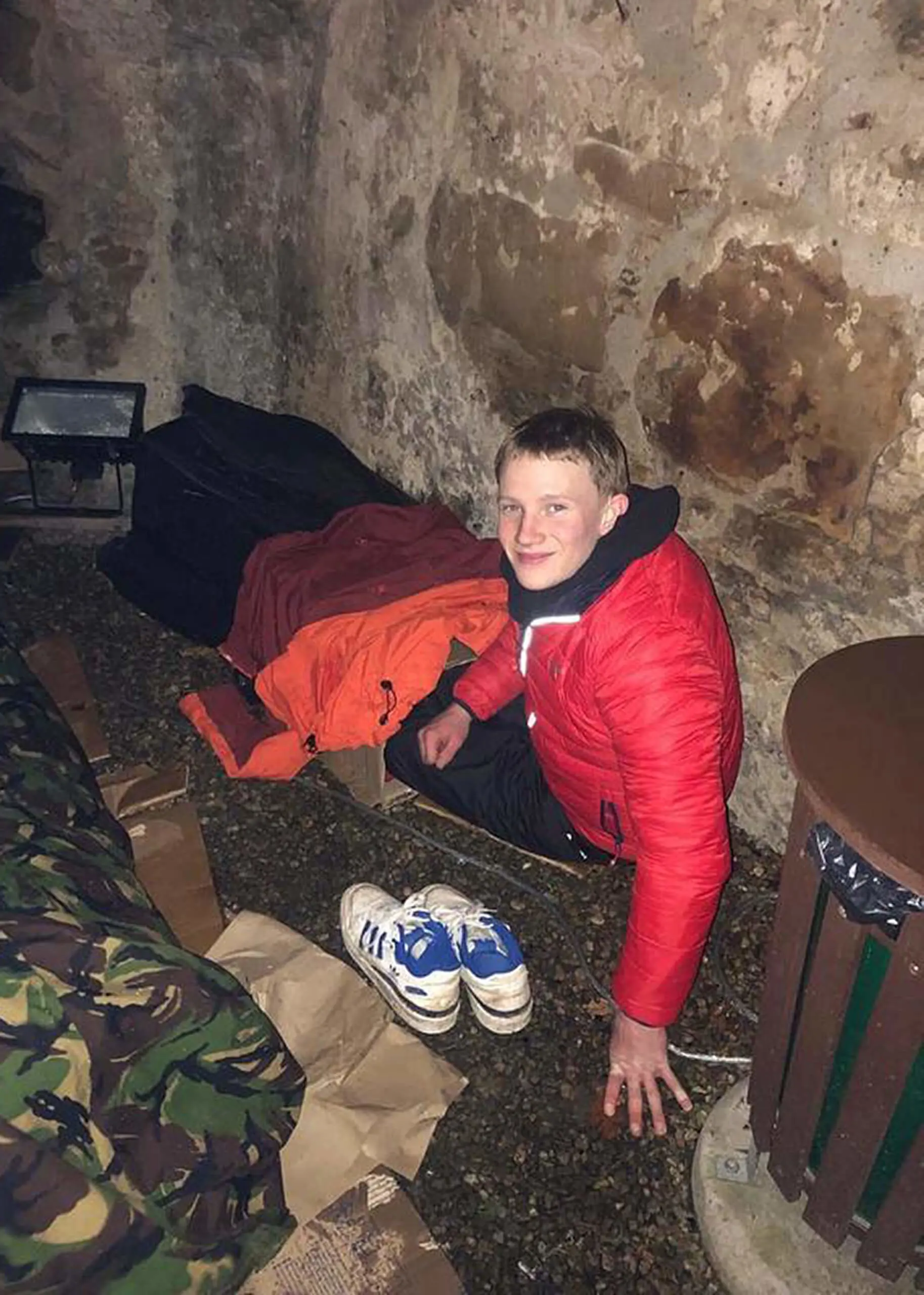 Smiling despite the cold, one student settles down for the night