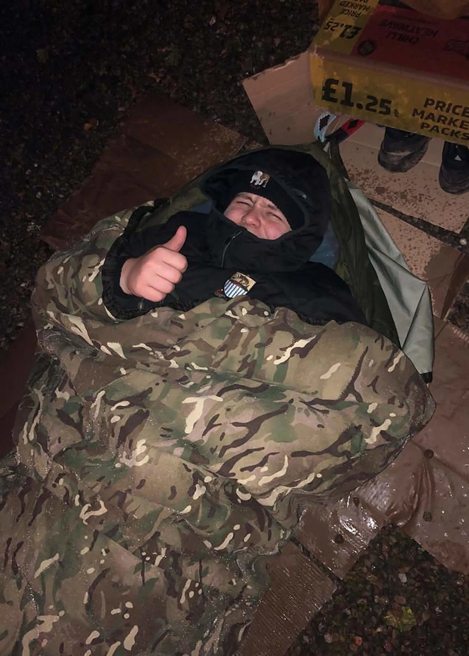 Student settles down for the night in sleeping bag