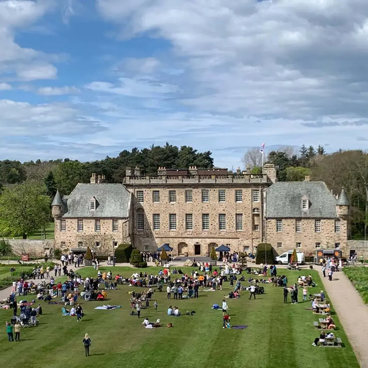 Gordonstoun families past, present and future relaxing on the South lawn with their picnics.